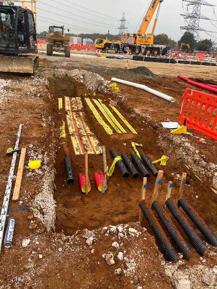 Cable trench with ducts and marker tape before backfill